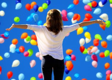 Image of women arms stretched out balloons